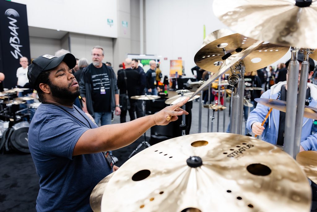 DrumFest at PASIC featuring drummer Keio Stroud testing cymbals