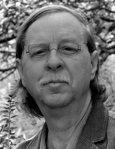 Gordon Stout headshot in black and white. White man with glasses, approximately aged 60.