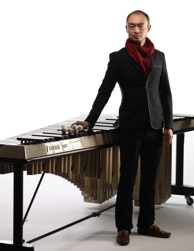 Pius Cheung stands in front of Yamaha keyboard instrument