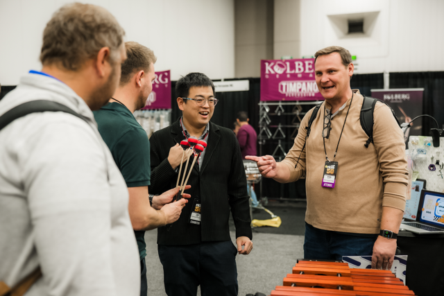 PASIC Expo Hall in 2025 customers look at mallets in front of marimba
