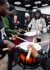 Drummers from the Million Dollar Funk Squad, Norfolk State University's Drumline, try out marching snare drums at the PASIC Exhibition. 