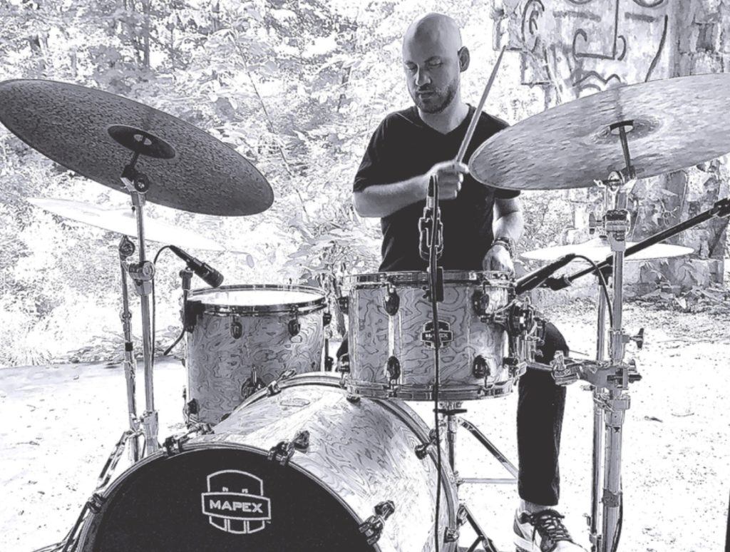 Adam Hopper playing a drumset